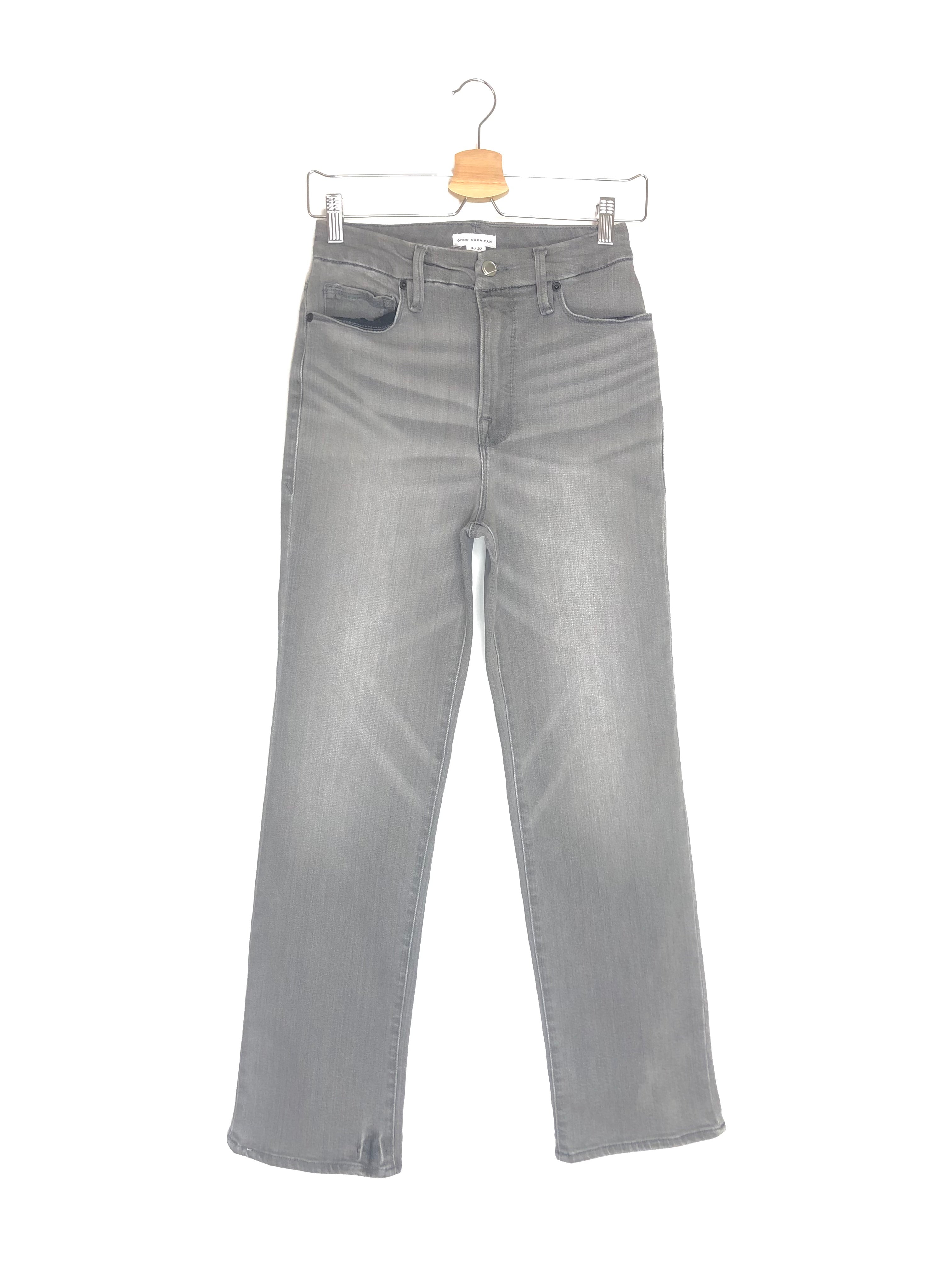 Gray jeans on a hanger against a white background