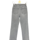Gray jeans on a hanger against a white background