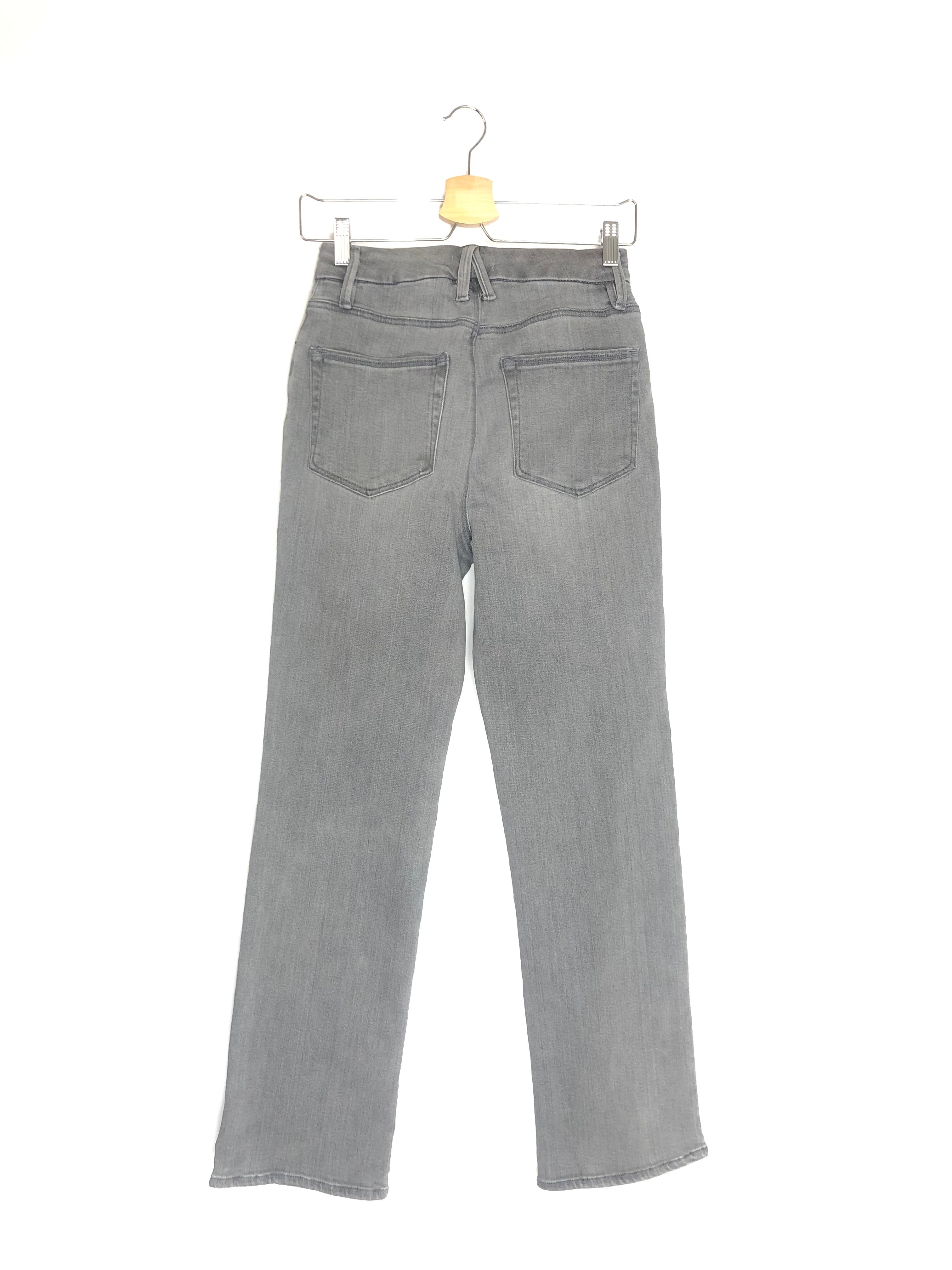 Gray jeans on a hanger against a white background