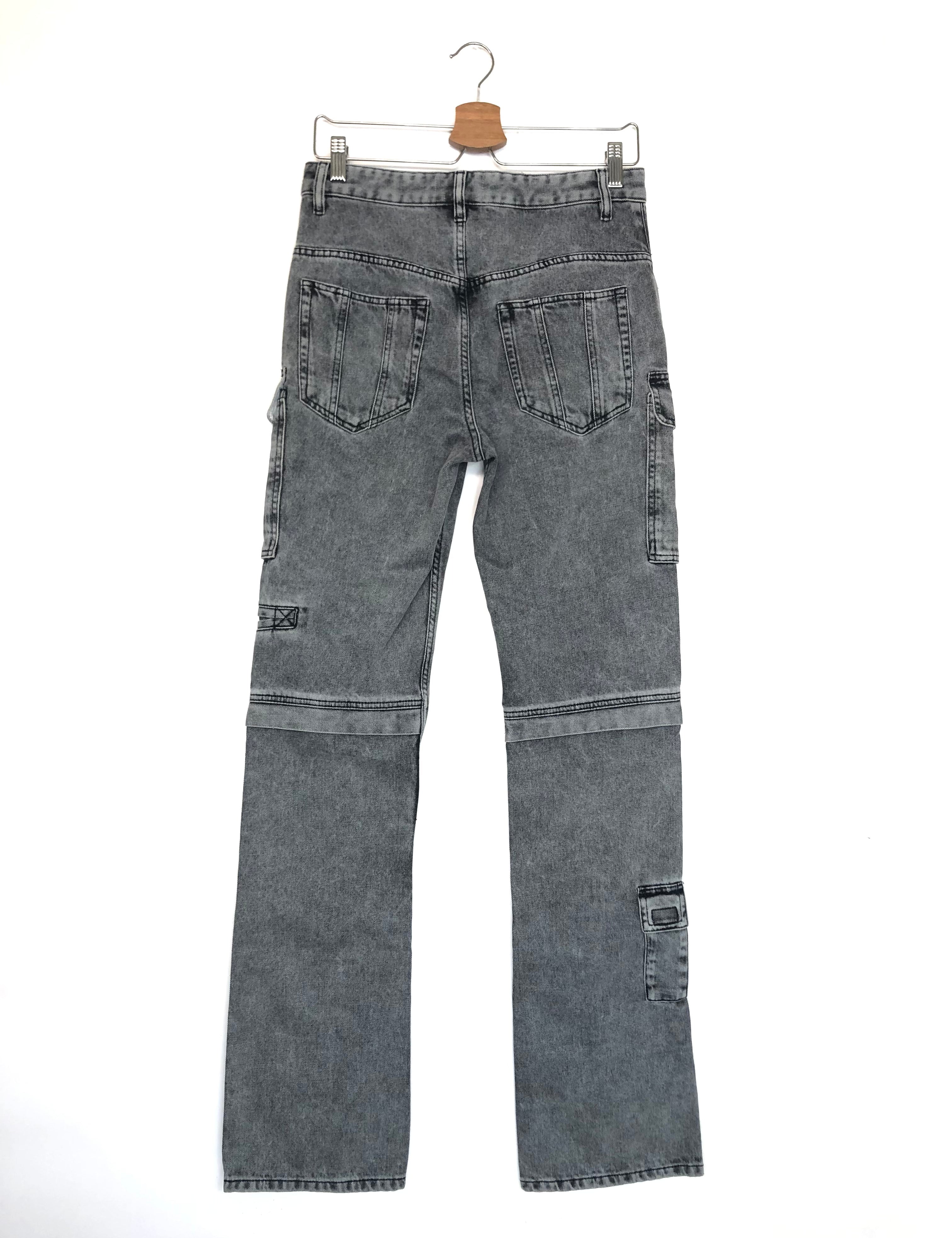 Gray denim jeans on a hanger against a white background