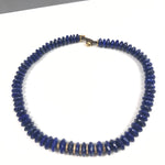 Blue beaded necklace on a white background