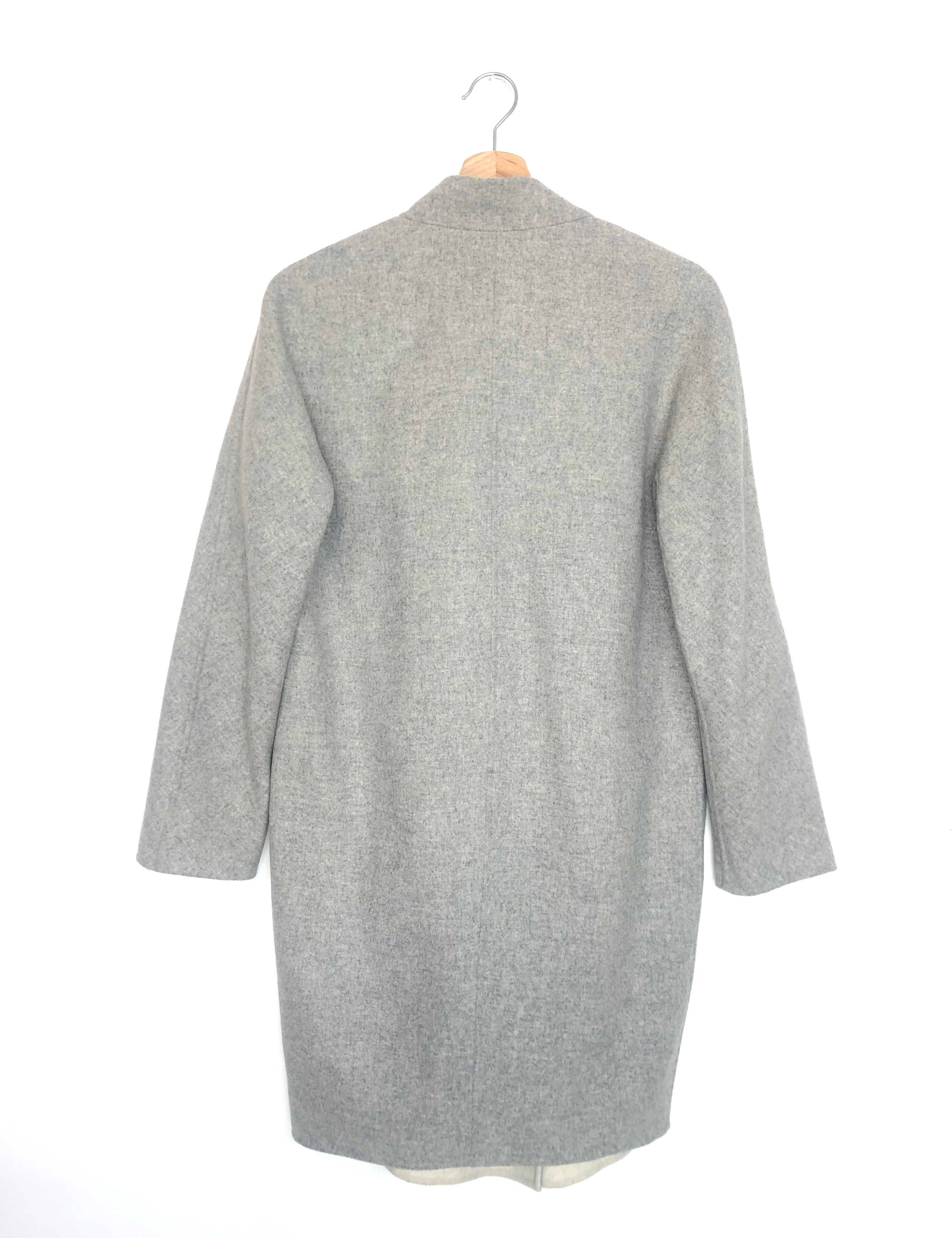 Gray coat on a hanger against a white background