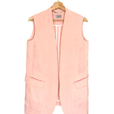 Pink vest on a hanger against a white background