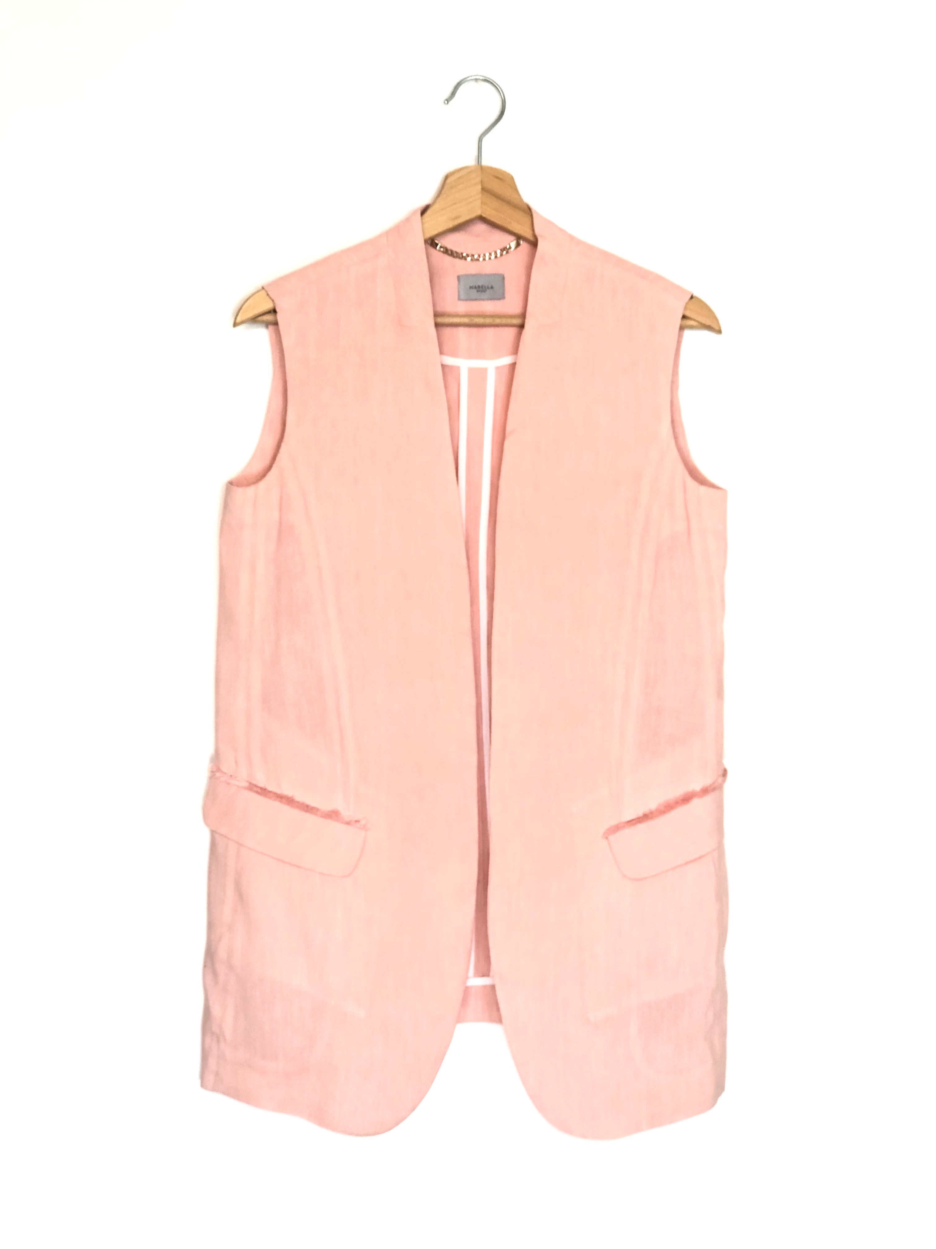Pink vest on a hanger against a white background