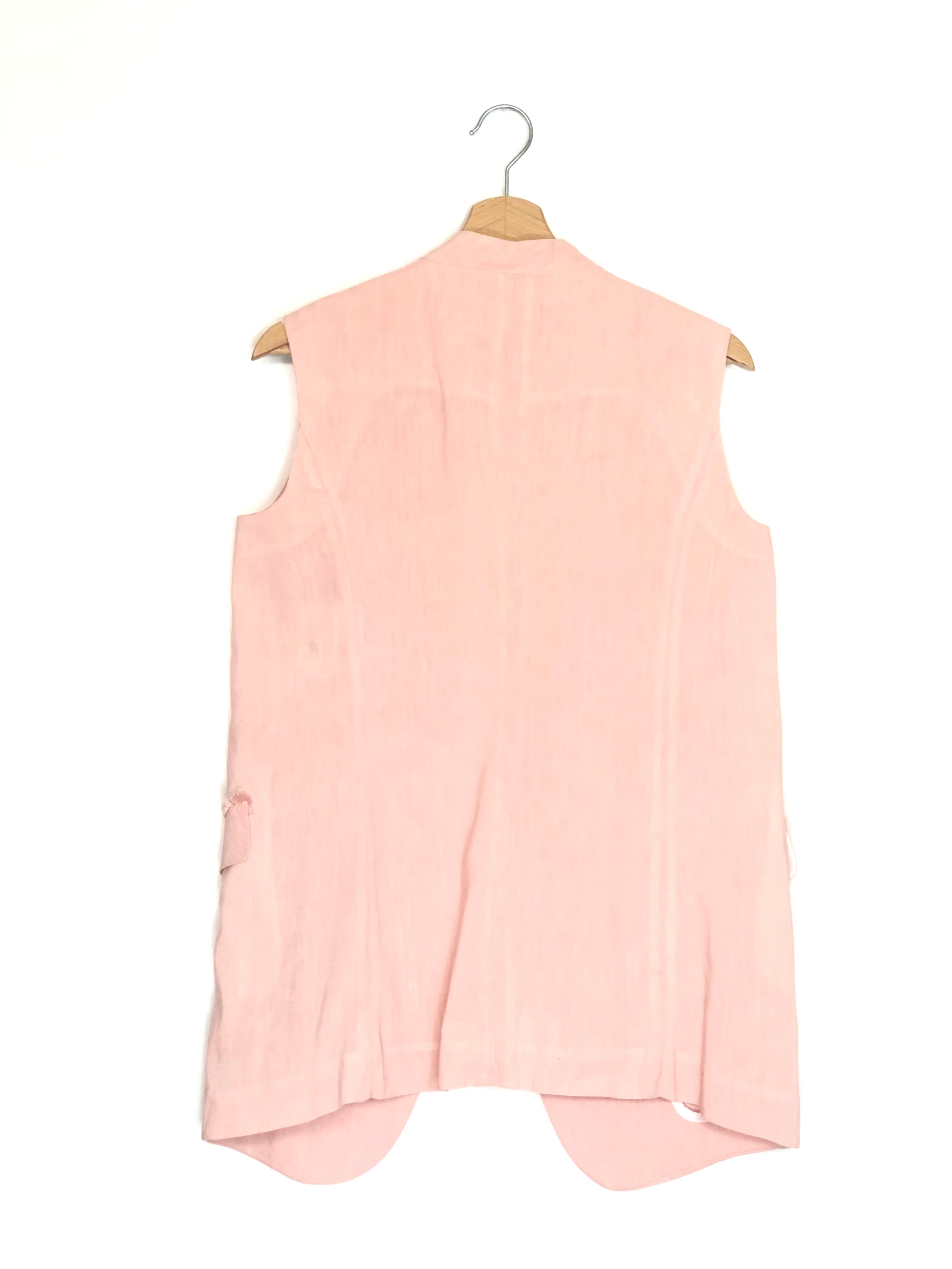 Pink sleeveless blazer on a hanger against a white background