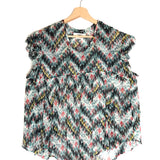 Floral patterned blouse on a hanger against a white background