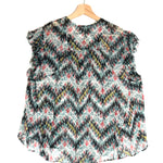 Floral and zigzag patterned top on a hanger against a white background
