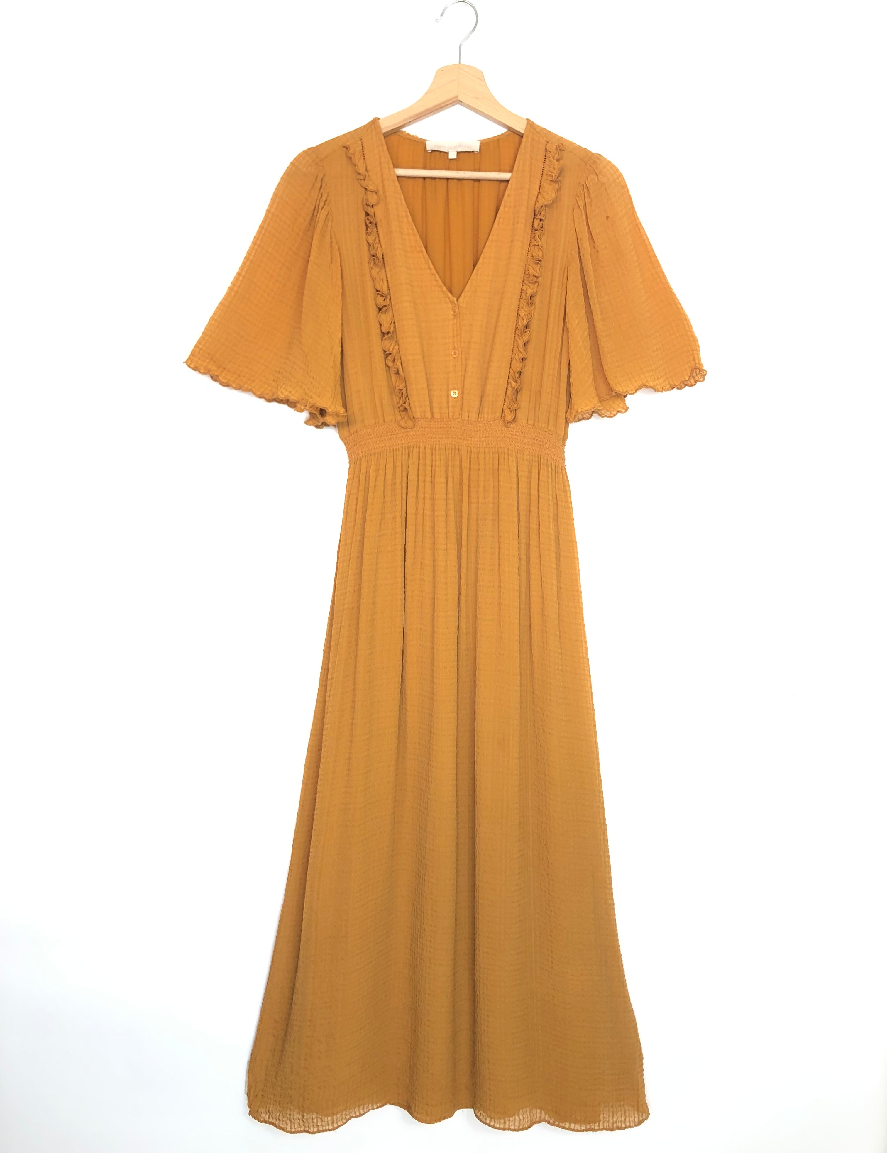 Mustard yellow dress on a white background