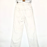 White pants on a hanger against a white background