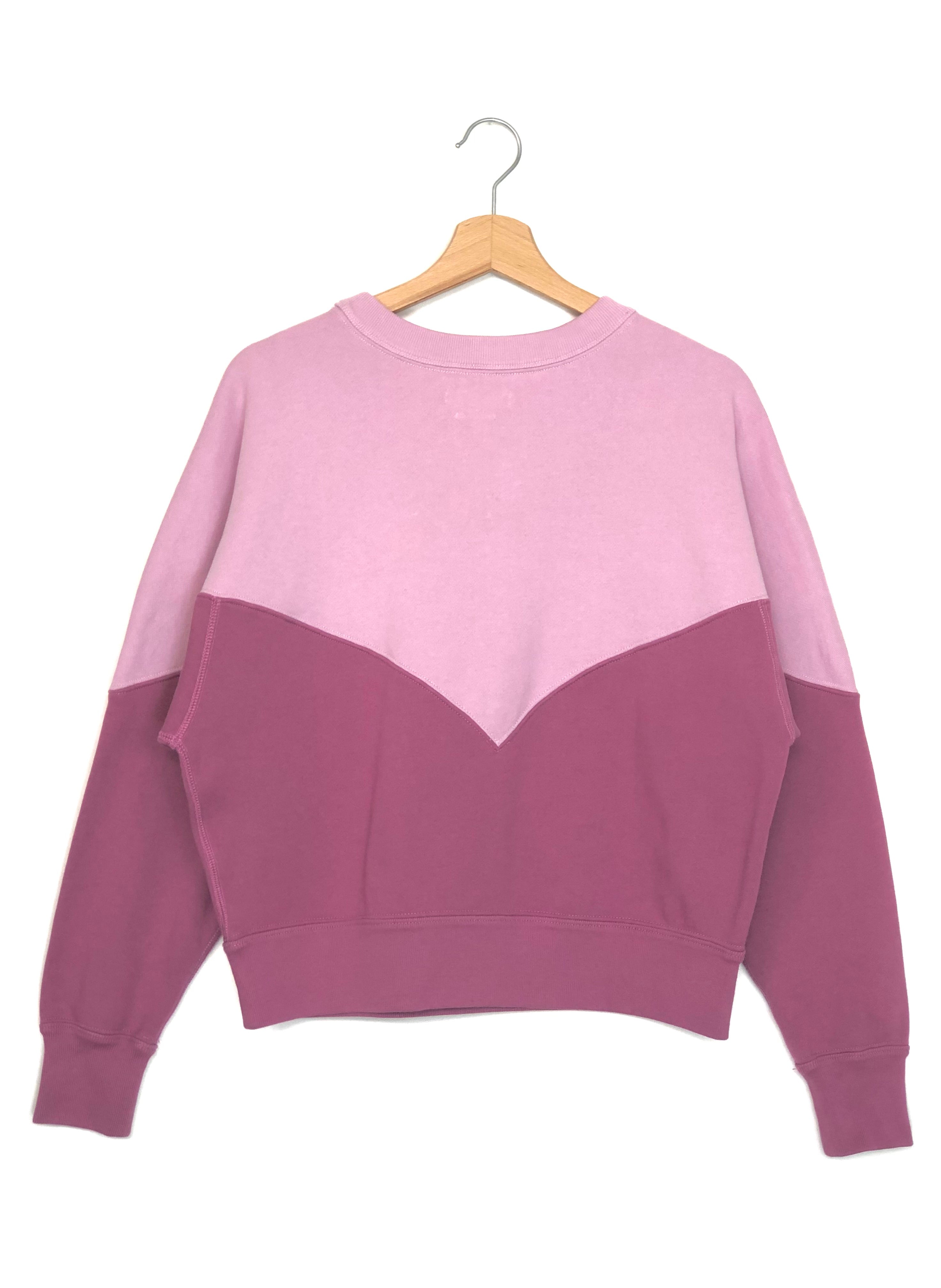 Two-tone pink and purple sweatshirt on a hanger against a white background