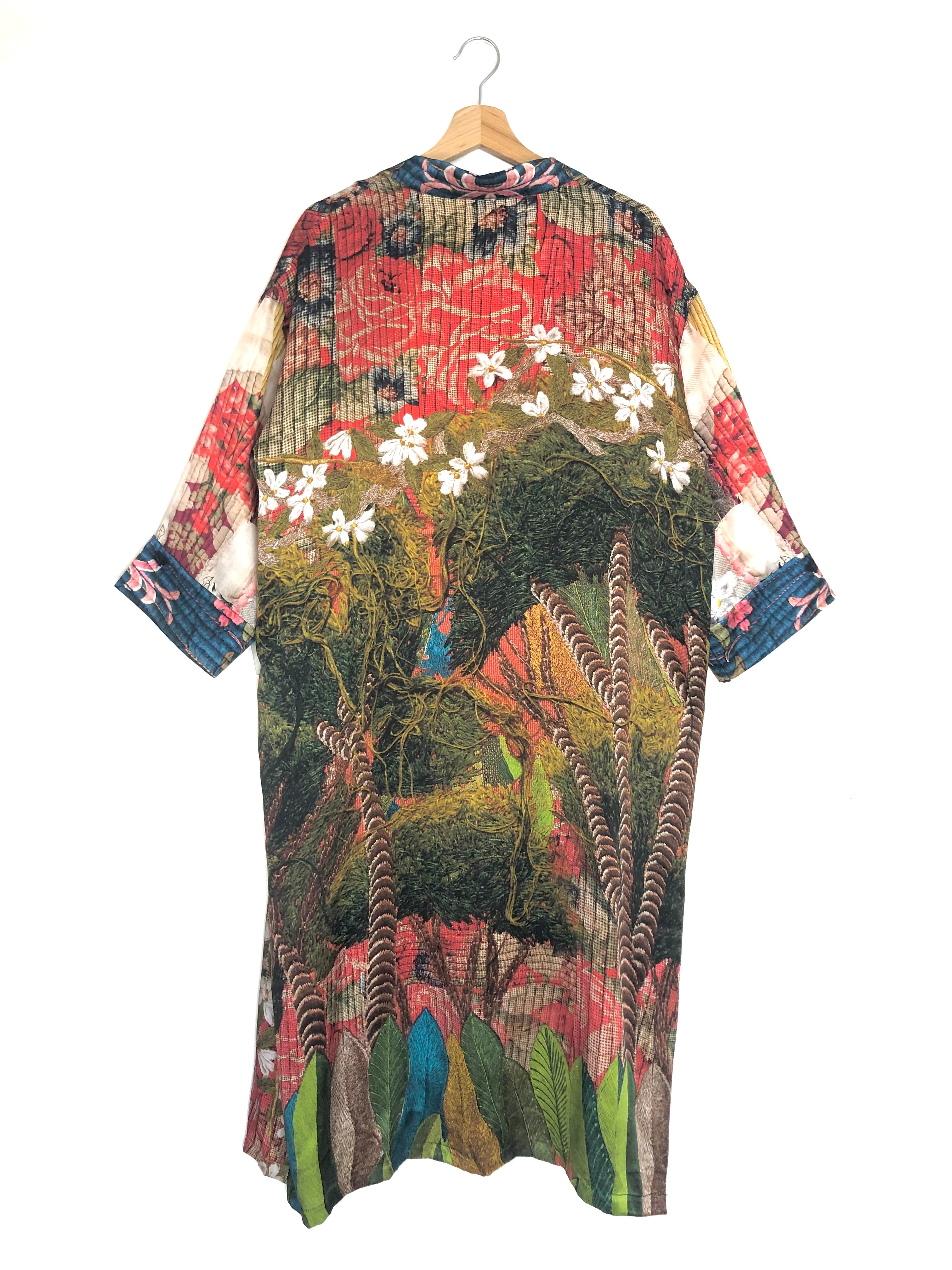 Colorful patterned kimono on a hanger against a white background