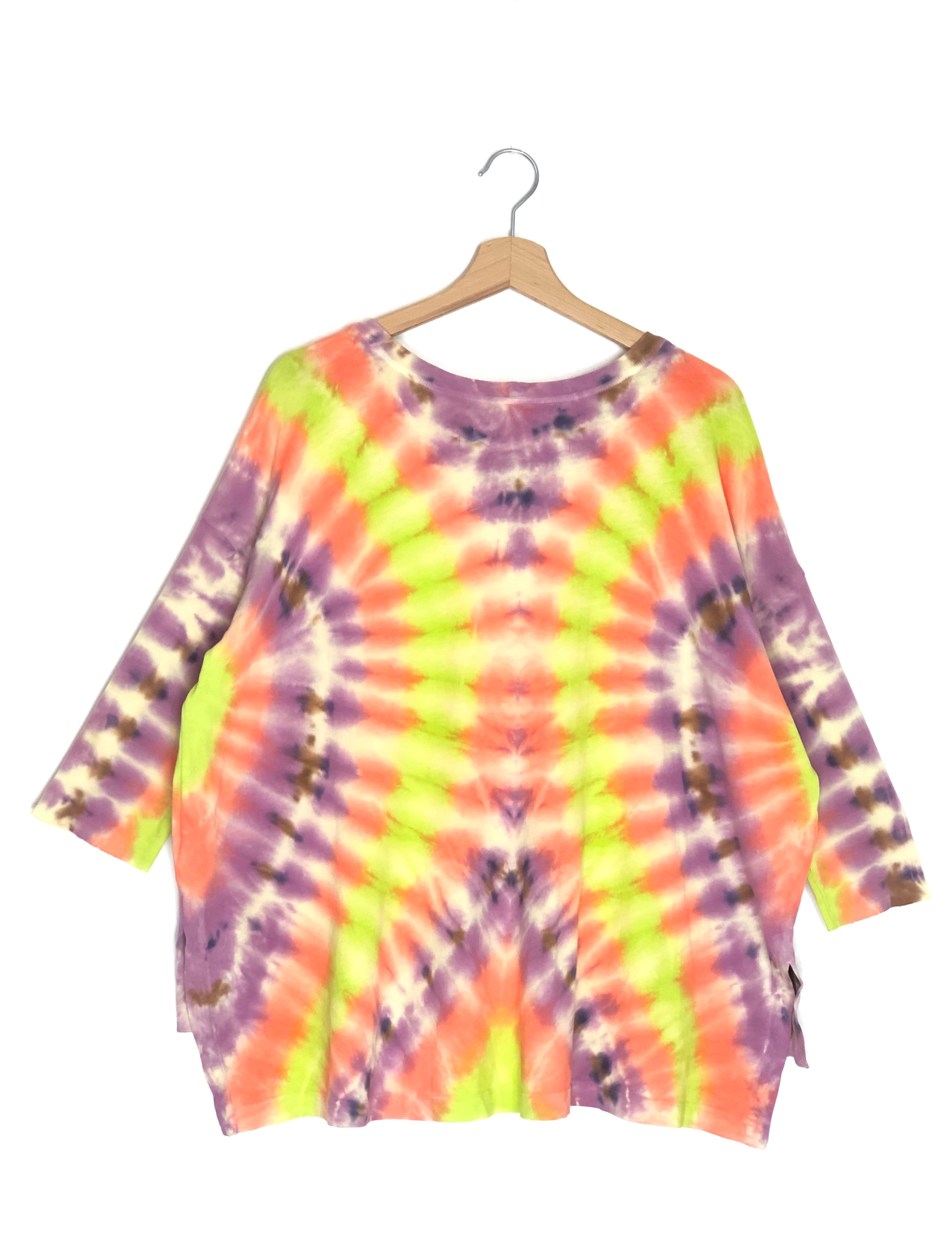 Tie-dye shirt on a hanger with a white background