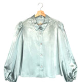 Rain-blue blouse on a hanger against a white background