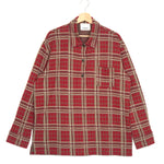 Red and beige plaid shirt on a hanger against a white background