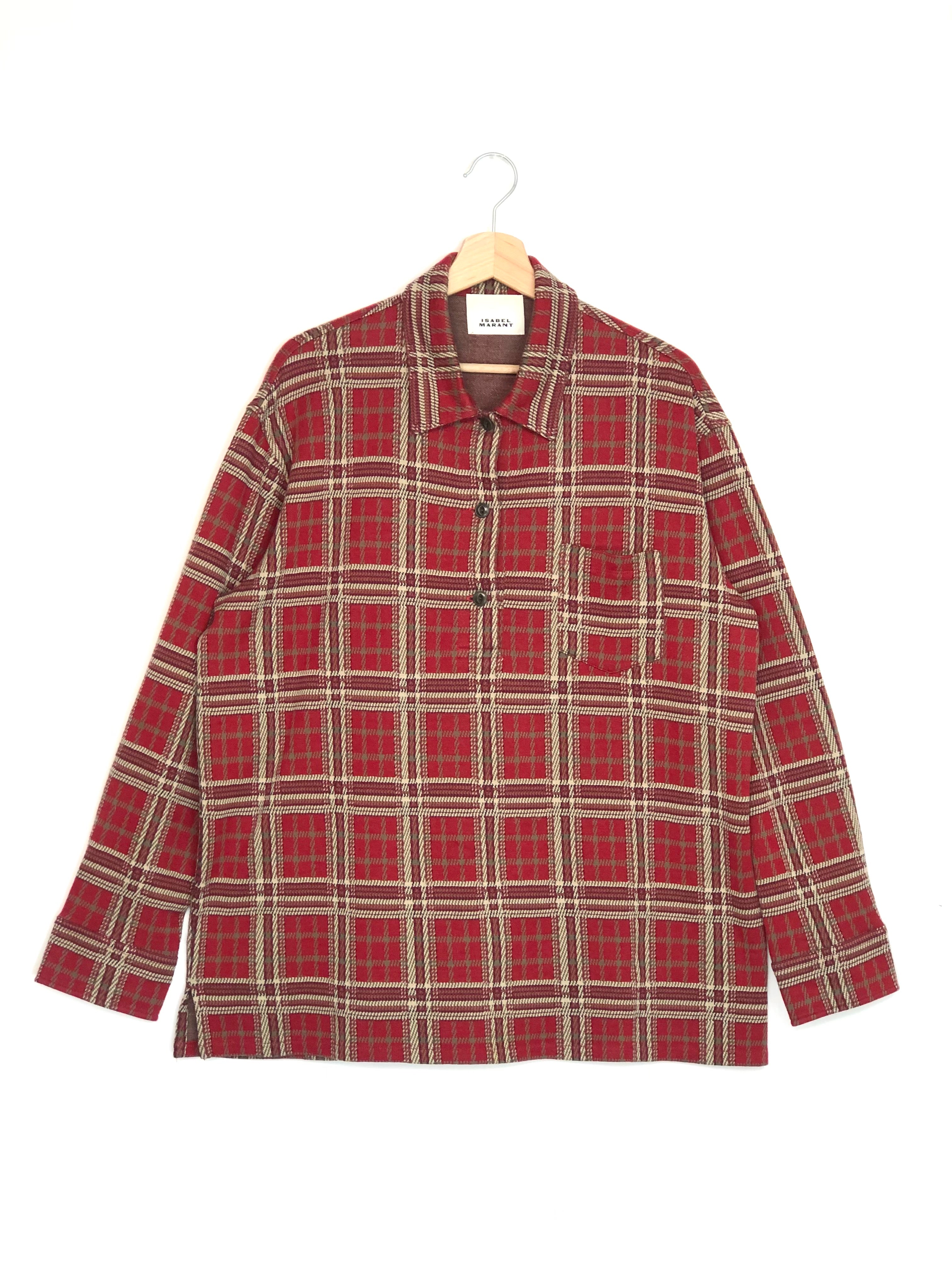 Red and beige plaid shirt on a hanger against a white background