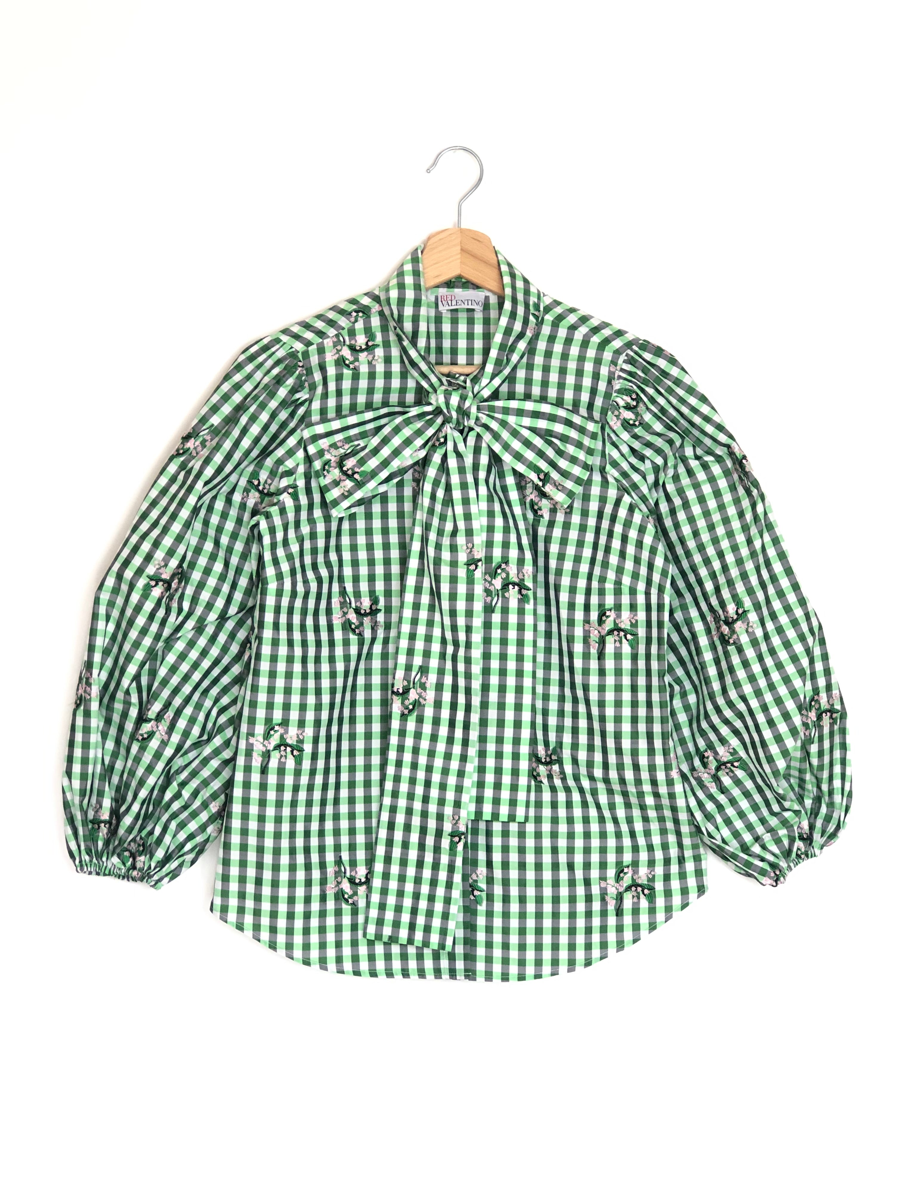 Green checkered shirt with a bow on a white background