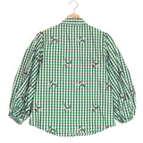 Green checkered shirt with embroidered details on a hanger against a white background