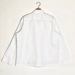 White shirt on a hanger against a white background