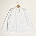 White shirt on a hanger against a white background