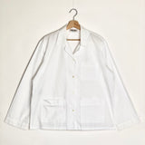 White shirt on a hanger against a white background