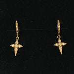 Pair of gold star-shaped earrings on a black background