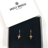 Star-shaped earrings in a box with Angele Brousse branding
