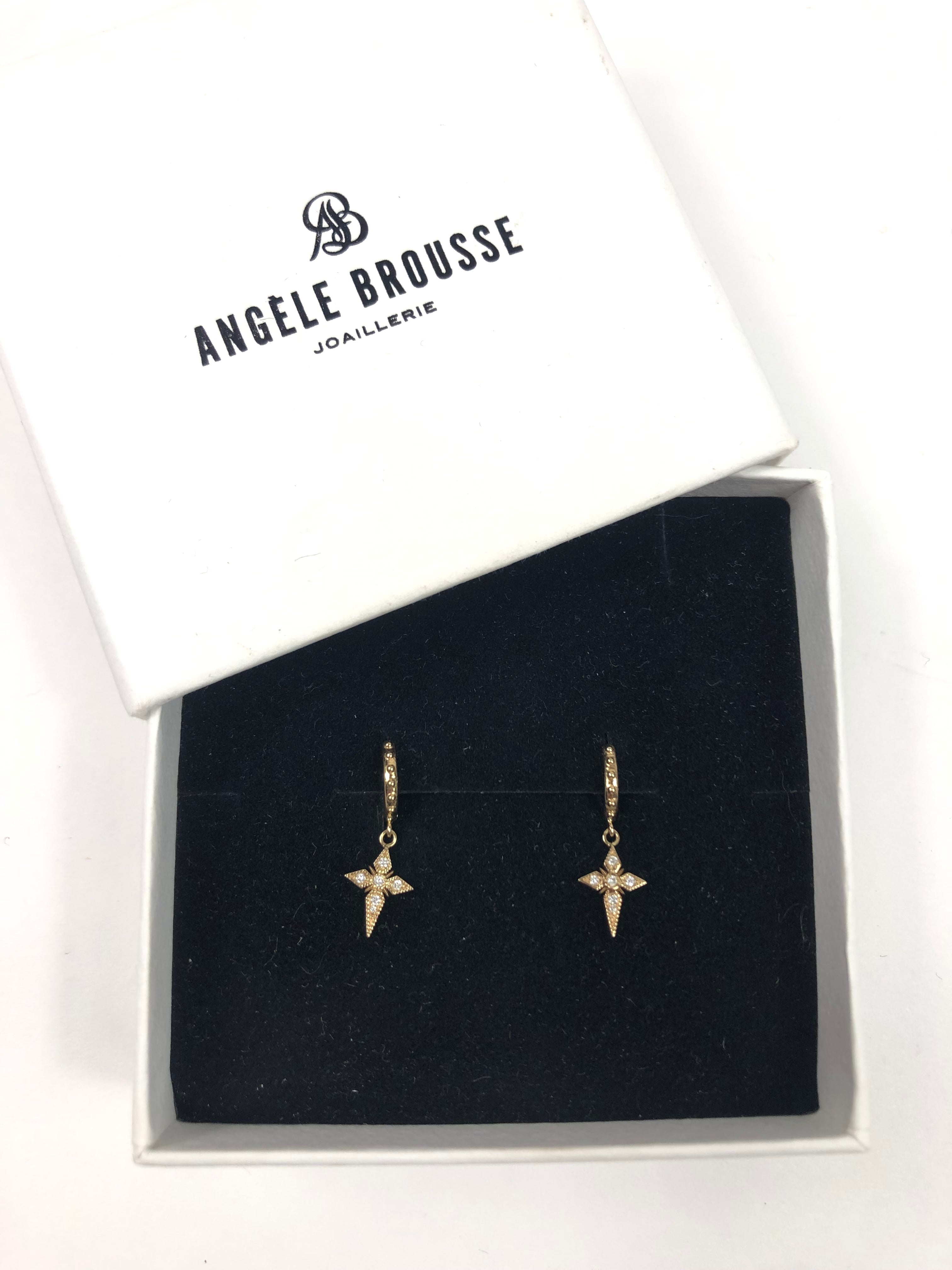 Star-shaped earrings in a box with Angele Brousse branding