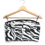 Zebra print strapless top on a wooden hanger against a white background